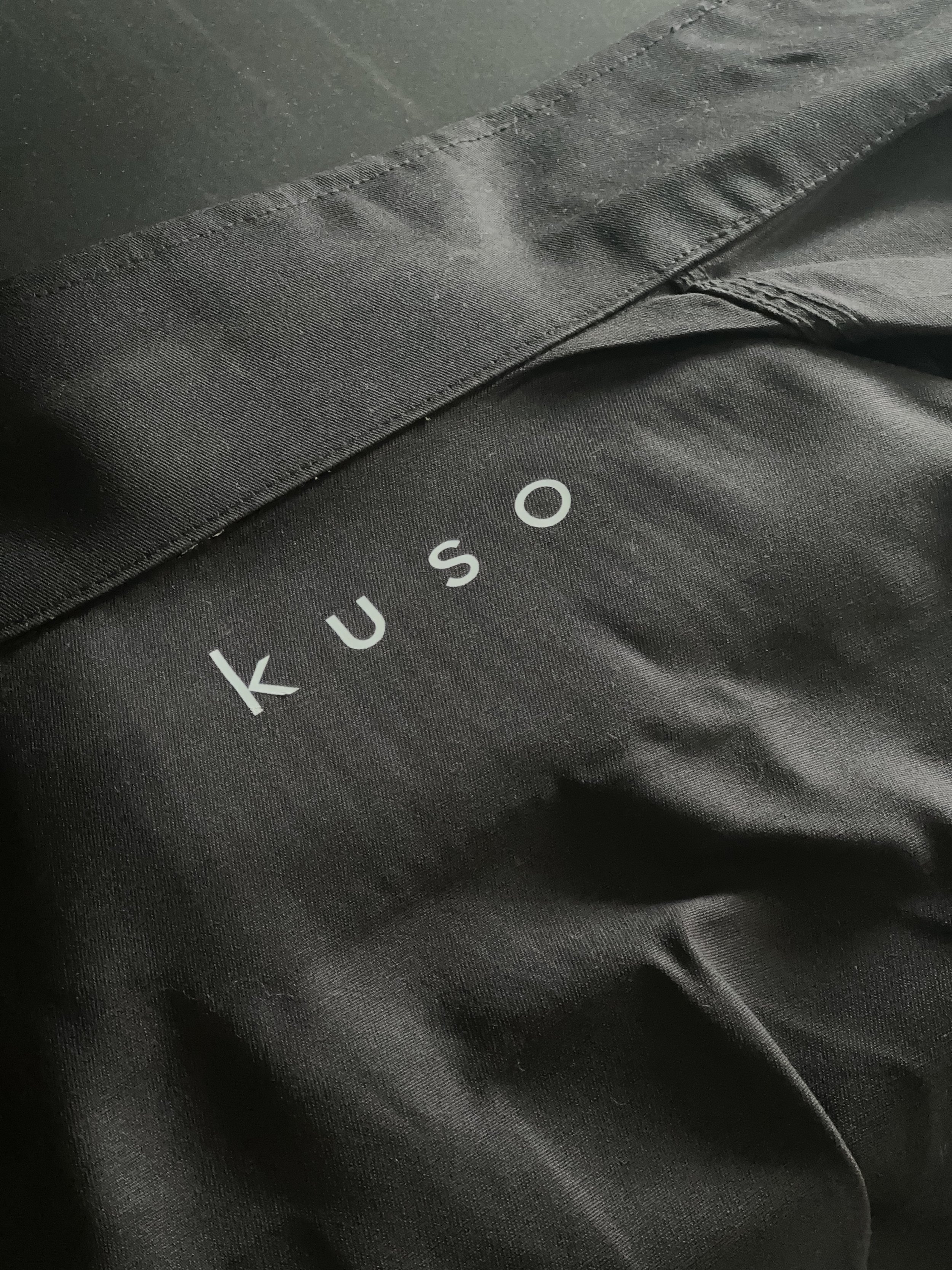 Black fabric with the brand name "Kuso" printed in white.